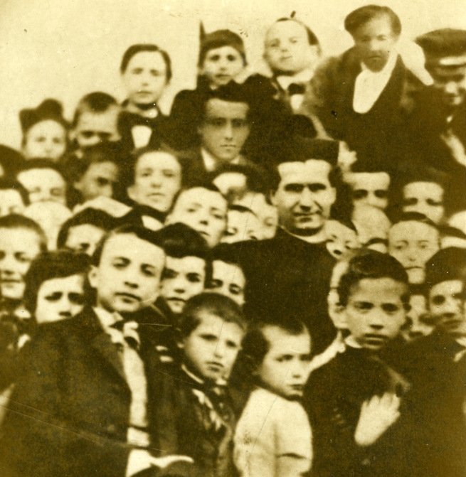 Old photograph of Don Bosco among the young